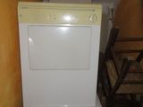 a white washer and dryer in a small room
