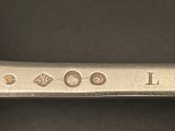 a close up of a silver spoon with a name engraved on it