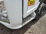 a white truck with a yellow and red sticker on the side of it