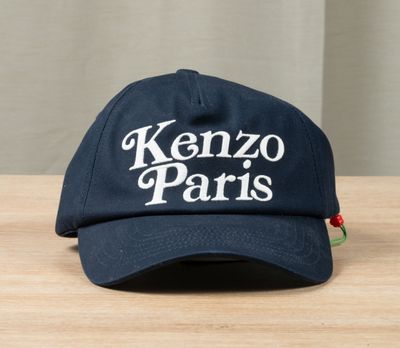 the kenzo paris hat is sitting on a wooden table