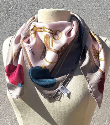 pink and blue scarf on mannequin torso with white background
