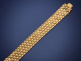 a gold bracelet on a blue background
