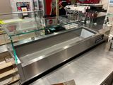 a counter with a glass display case in the middle of it