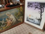 two framed pictures of a woman and a child on the floor