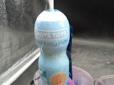 purple and blue liquid in a blender next to a bottle of toothpaste