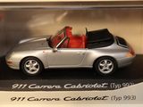 a silver toy car in a display case with a red seat