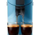 a blue coffee machine with two cups of coffee on it