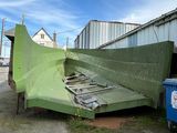 a green plane that is sitting on the ground
