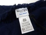 the label of a blue jacket with a white tag on it
