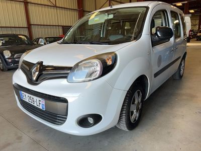 the small white van is parked in a garage with other cars