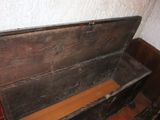 an old wooden chest with a wooden lid