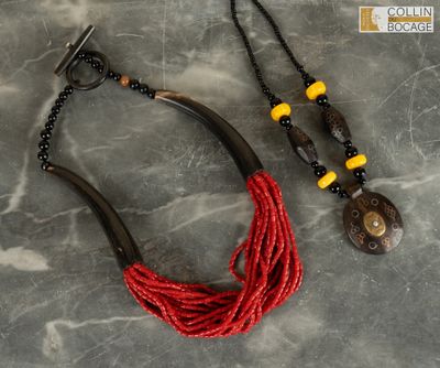 a close up of a necklace and a pair of earrings on a table