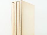 three books stacked on top of each other on a white surface