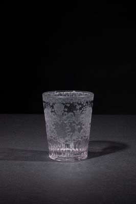 a shot glass sitting on a table with a black background