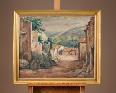 a painting on a easel with a painting of a village in the background