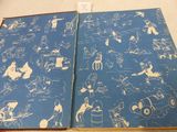 a blue book with drawings of people and animals on it