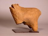 statue of a bull on a wooden base on a white background