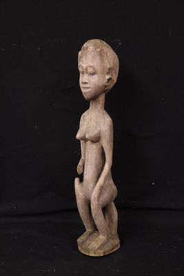 a wooden statue of a woman holding a baby in her arms
