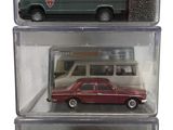 three toy cars that are in a display case