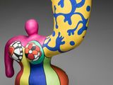 an image of a figurine of a man with a banana on his head