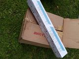 a cardboard box and a pair of scissors on the grass