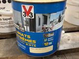 a close up of a bucket of paint sitting on a pallet