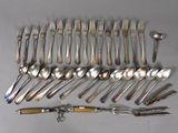 a lot of spoons and forks laid out on the table