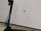 a scooter that is parked in front of a garage door