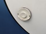 a close up of a button on a white and blue surfboard