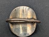 a close up of a metal object on a black surface