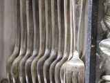 a bunch of forks and spoons in a blue box