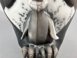 a close up of a ceramic owl statue on a table