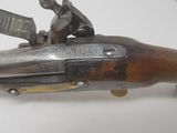 a close up of a gun on a table with a white background