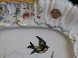 a plate with a bird painted on it