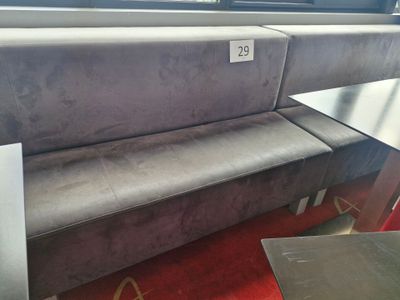 a couch and a table in a room with a red carpet
