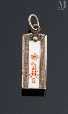 a close up of a silver and enamel pendant with a crown on it
