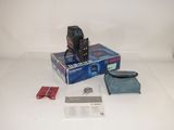 a box with a camera and other items on the table