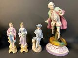 five figurines of people standing on a table