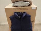 a pile of clothes on a pallet next to a box