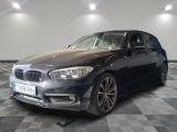 a picture of a black bmw car in a showroom