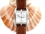 a watch that is sitting on top of a shell
