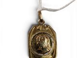 an image of a gold necklace with a picture of a woman on it