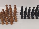 a group of chess pieces sitting on top of a white surface