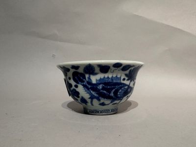 a blue and white bowl with a fish design on it