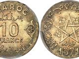 une pièce d'or avec une étoile au recto et une étoile au verso