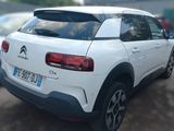 the rear end of a white citrole parked in a parking lot