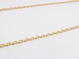 a close up of a gold chain on a white background