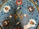 a clock that is sitting on top of a plate