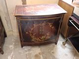 a small cabinet with a floral design on it