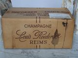 a box of champagne sitting on a table next to two vases